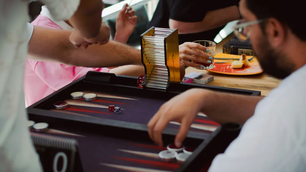 Backgammon move with a dice cup and doubling cube